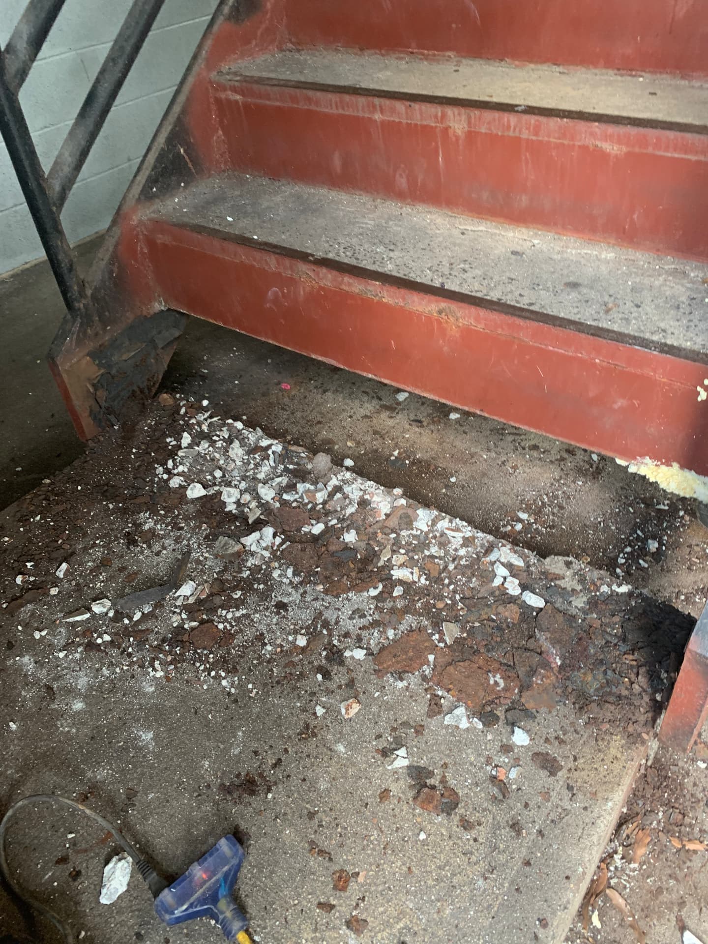 Damaged lower concrete stair before repair