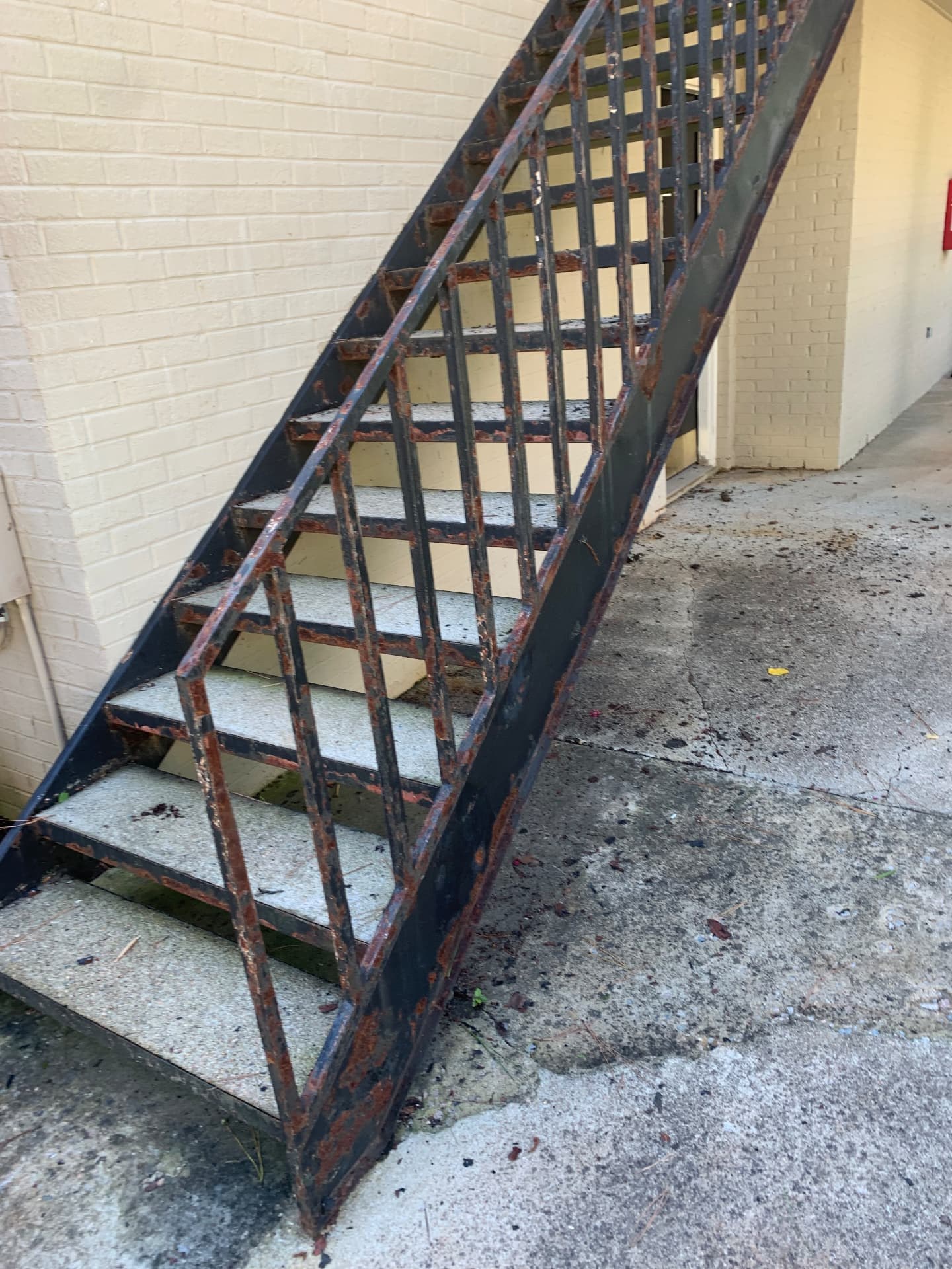 Weathered exterior steel staircase before work
